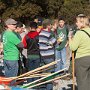 Volunteers pick up tools and receive instructions before starting to work.