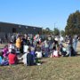 Volunteers sit down on the now cleaned up area to enjoy their pizza lunch. 